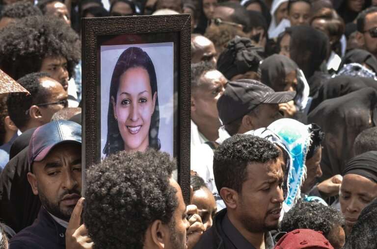 Mourners in Addis Ababa, Ethiopia carry portraits of victims from the Ethiopian Airlines crash