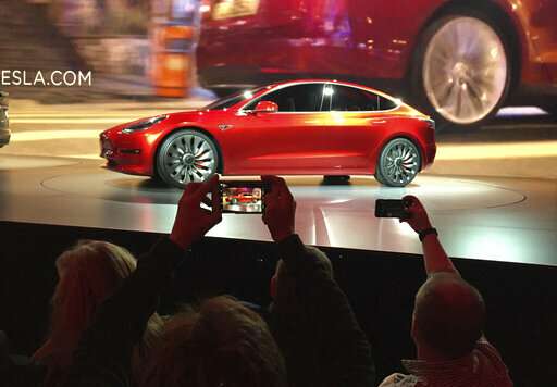 On the road to make an affordable car, Tesla cuts jobs