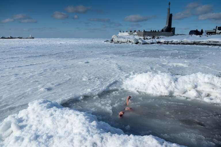Orthodox believers in Russia plunge into icy pools at Epiphany as part of a religious tradition