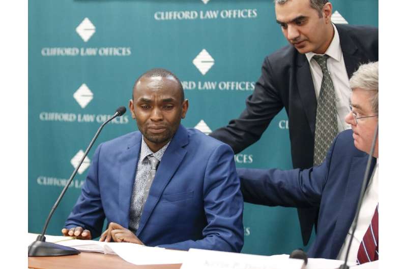 Paul Njoroge, who lost his entire immediate family, at a press conference in Chicago, last month after his lawyers announced a l