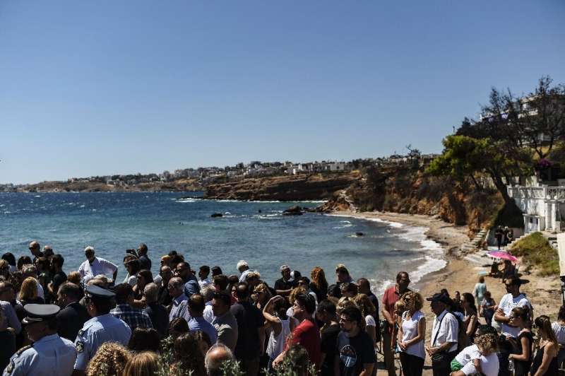 People gathered on the beach Sunday for a memorial ceremony in memory of the victims of the wildfire