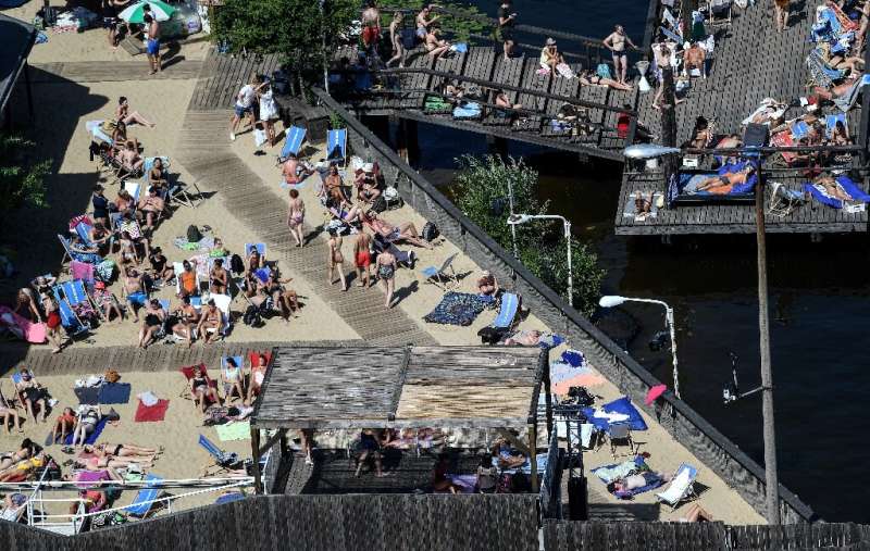 People in Berlin took to a beach at a public pool on the river Spree to try and cool off