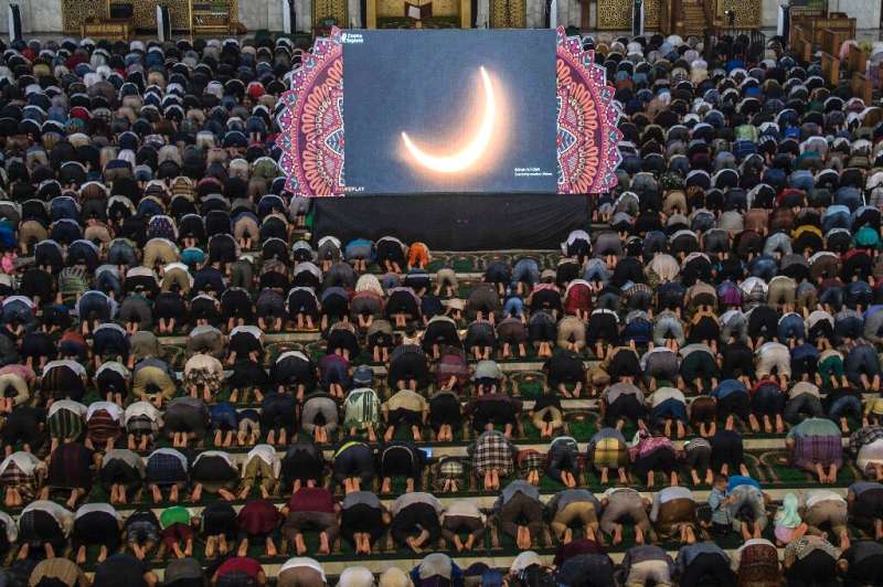 People in Surabaya, Indonesia pray for the eclipse during the rare &quot;ring of fire&quot; solar eclipse