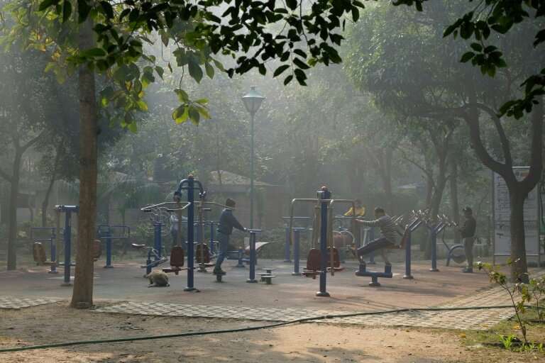 People still exercise on a morning of heavy air pollution at Lodhi Gardens in New Delhi