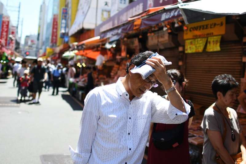 People walk on a hot day in Tokyo, in August 2019—average global temperature between 2015-2019 is on track to be the hottest of 
