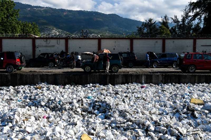 Plastic waste is seen floating on a sewage canal in the Haitian capital Port-au-Prince, on April 23, 2019. Around 180 government