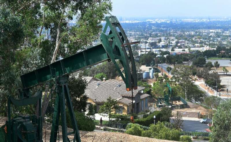 Pumpjacks in an oil well are seen on September 25, 2019 near Hilltop Park overlooking the city of Signal Hill, California, where