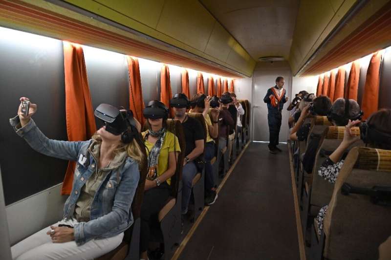 Reporters get to grips wth Timeride's tours using VR goggles—choosing from a trio of characters to &quot;lead&quot; them through