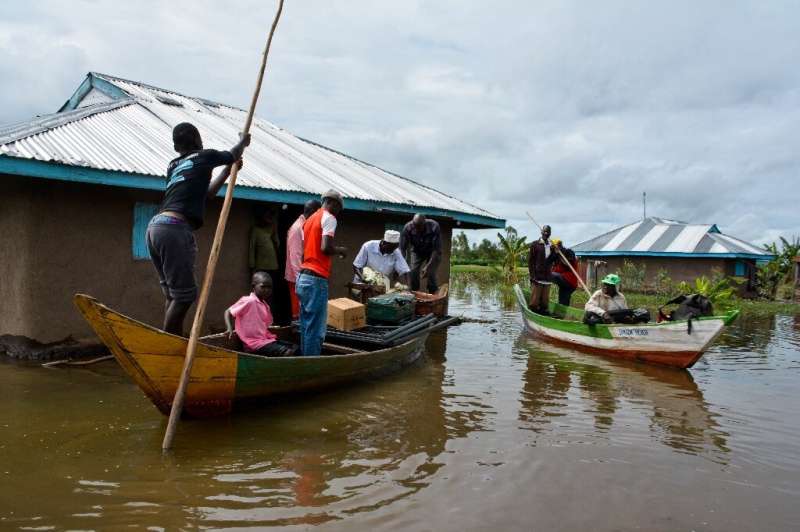 Rescue boats evacuate families after their houses were flooded in Kenya