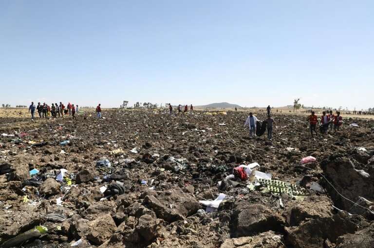 Rescue teams search for the remains of victims of the Ethiopian Airlines crash—the doomed jet was a Boeing 737 MAX