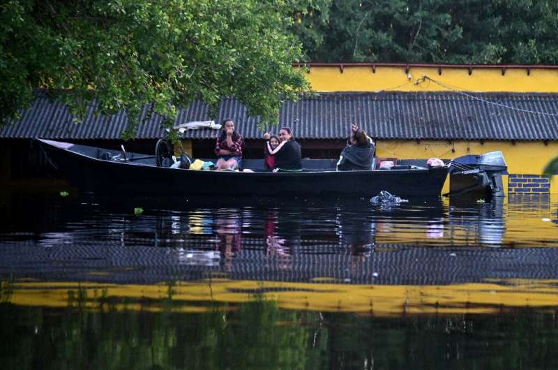 Residents of Nanawa, over the river from Paraguay's capital Asuncion, have to move around by boat in their home town
