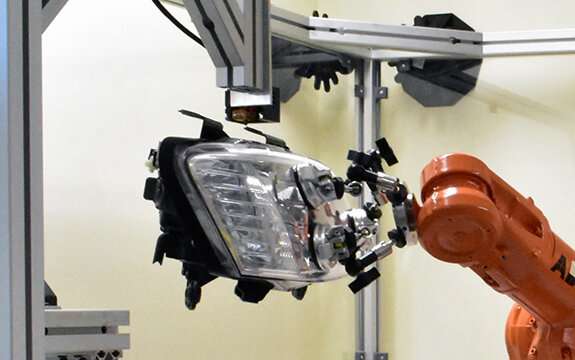 Robot 3-D prints replacement bracket on headlamp