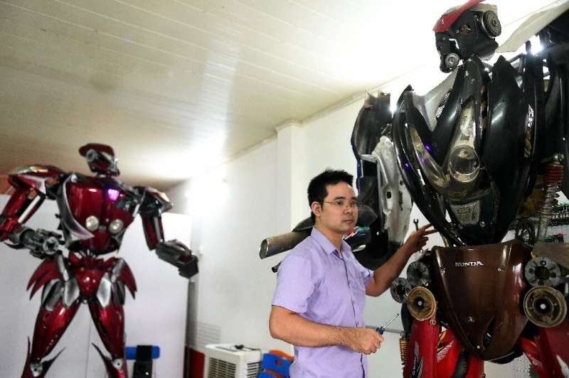 Robot One (L) is just the first of many, the engineers say, with dreams of creating a robot park in Hanoi one day