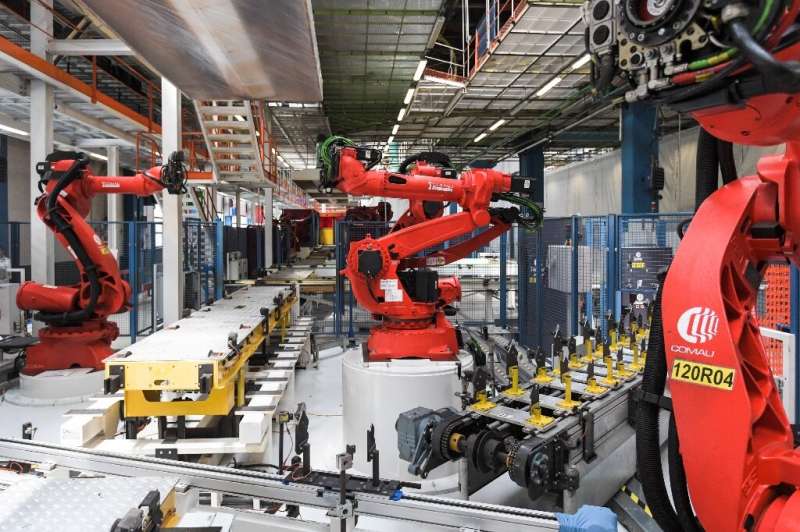 Robots manufactured by Comau are pictured on the assembly line of the Fiat 500 BEV Battery Electric Vehicle, the first of its ki
