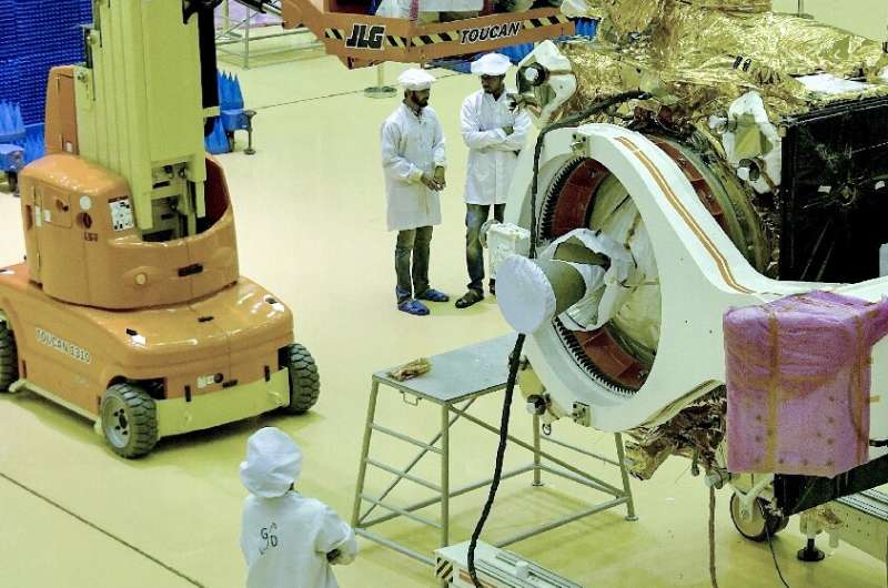 Scientists work on the orbiter vehicle of India's first moon lander