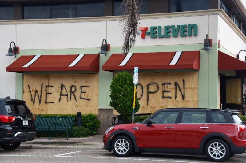 Shop windows are boarded up as Hurricane Dorian approaches Deerfield Beach, Florida