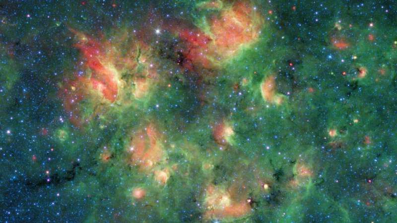 Spitzer spots a starry region bursting with bubbles