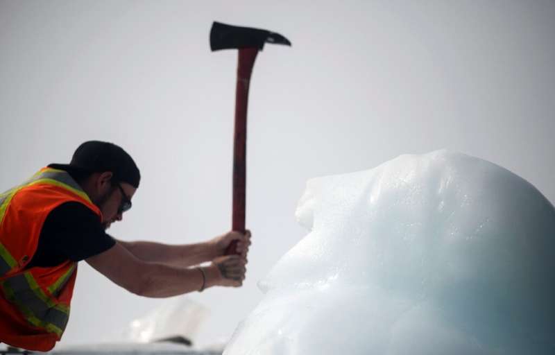 Taylor Lindsorn chops blocks off an iceberg with an ax—the tools of the trade have hardly changed over the years
