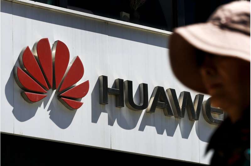 Tech group eases stance on Huawei as Beijing lashes back