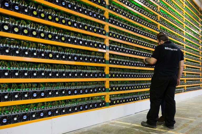 Technicians inspect bitcoin mining at Bitfarms in Saint Hyacinthe, Quebec
