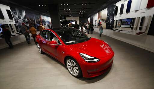 Tesla to close stores to reduce costs for $35,000 Model 3