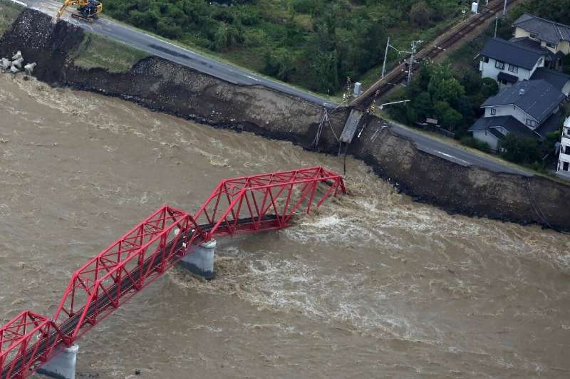 The Chikuma river, heavily swollen by rain from Typhoon Hagibis, swept away part of a train bridge in Ueda, in Japan's Nagano pr