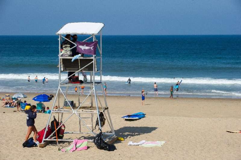 The purple flag on this lifeguard station warning of sharks should give swimmers pause when they dive into the waves