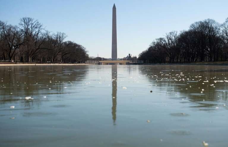 The Reflecting Pool on the National Mall in Washington is frozen as the region experiences frigid cold temperatures from a &quot
