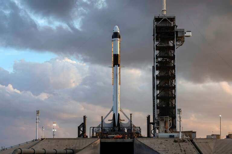 This image courtesy of SpaceX and obtained from NASA shows, the SpaceX Falcon 9 rocket and Crew Dragon spacecraft rolled out to 