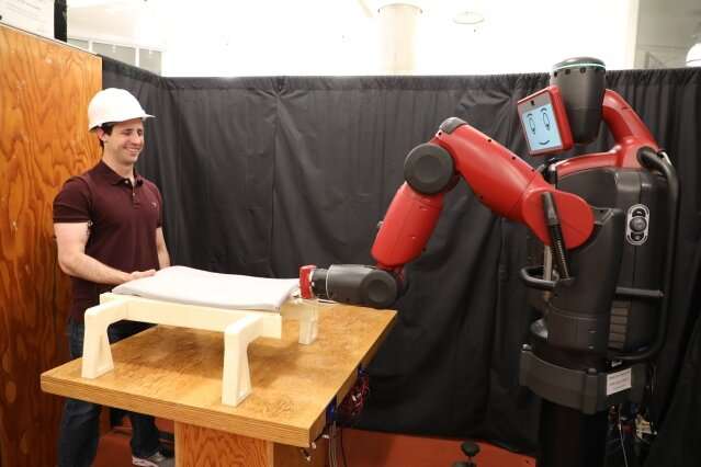 This robot helps you lift objects — by looking at your biceps