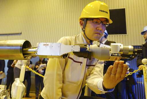 Toshiba unveils robot to probe melted Fukushima nuclear fuel