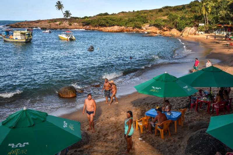 Tourists are seen on Calhetas beach in Pernambuco state in October 2019