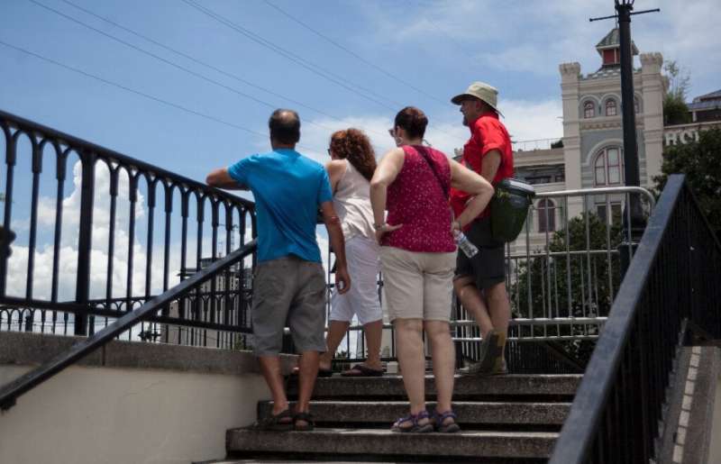 Tourists look out towards the Mississippi River at Artillery Park in New Orleans as Tropical Storm Barry approaches