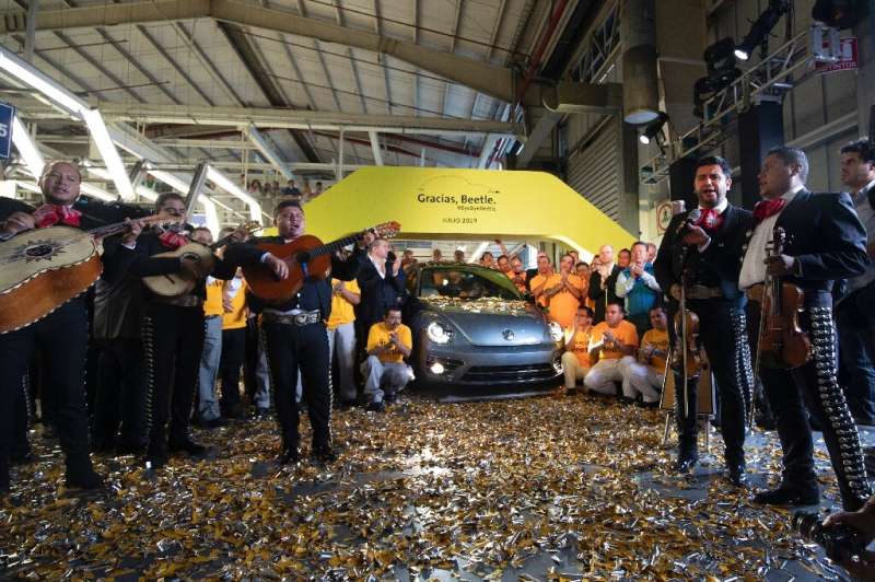 Volkswagen employees pose with a &quot;Beetle&quot;, the final edition of the iconic car, at a factory in Puebla, Puebla State, 