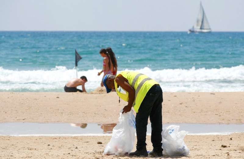 Volunteers join beach cleanups in Israel, whose Tel Aviv coastline was found to be the third most polluted by plastic waste in t