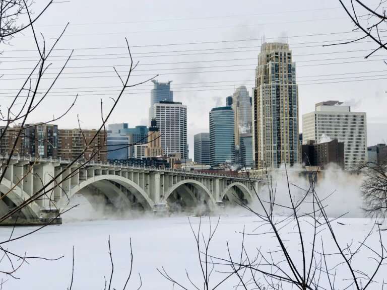 Water vapor rises above St. Anthony Falls on the Mississippi River beneath the Stone Arch Bridge during frigid temperatures on J