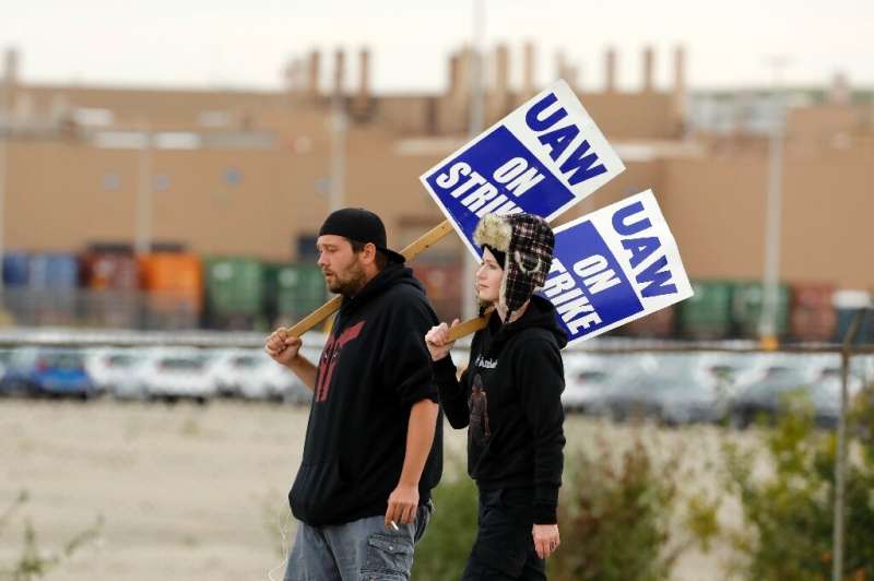 Workers walk the picket line outside General Motors Orion Assembly on October 11 in Orion Township, Michigan