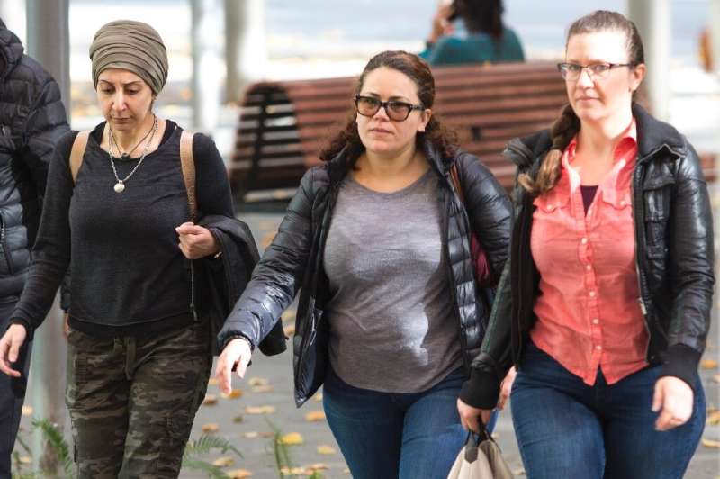 Zeina Abouammo, second left, whose husband, US citizen Ahmad Abouammo, is accused of using his position at Twitter to spy on acc