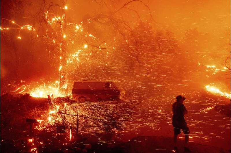 Californians flee as strong winds push fire through canyons