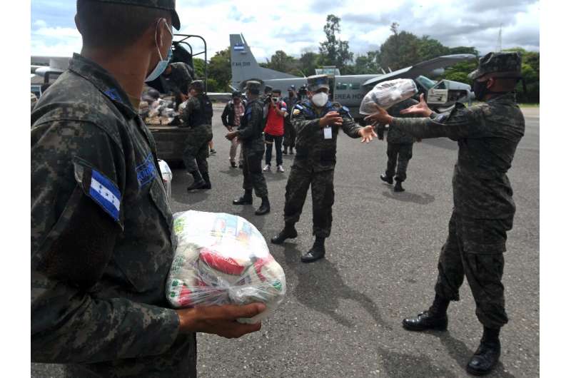 Honduran Air Force members load supplies to be taken to residents in the path of Hurricane Eta