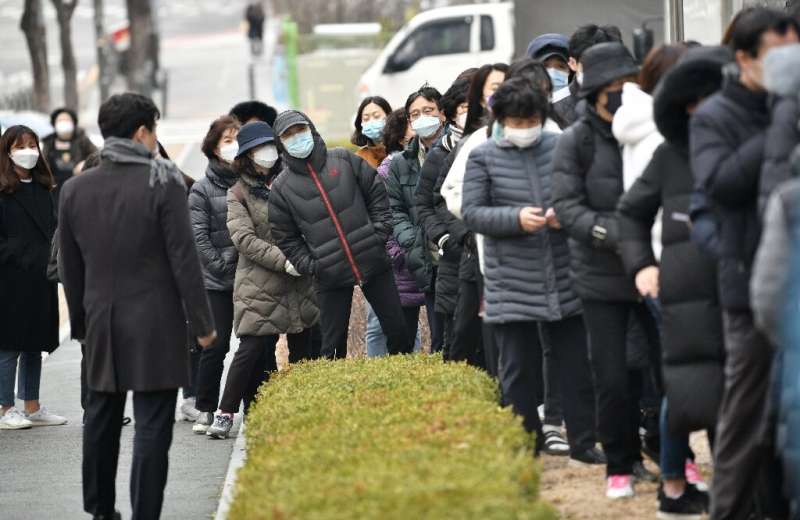 Huge lines formed at a Seoul supermarket as people arrived to buy face masks