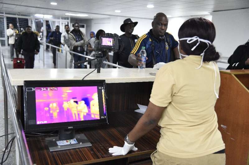 Passengers have their temperatures checked on arrival at the Murtala Mohammed International Airport in Lagos, Nigeria