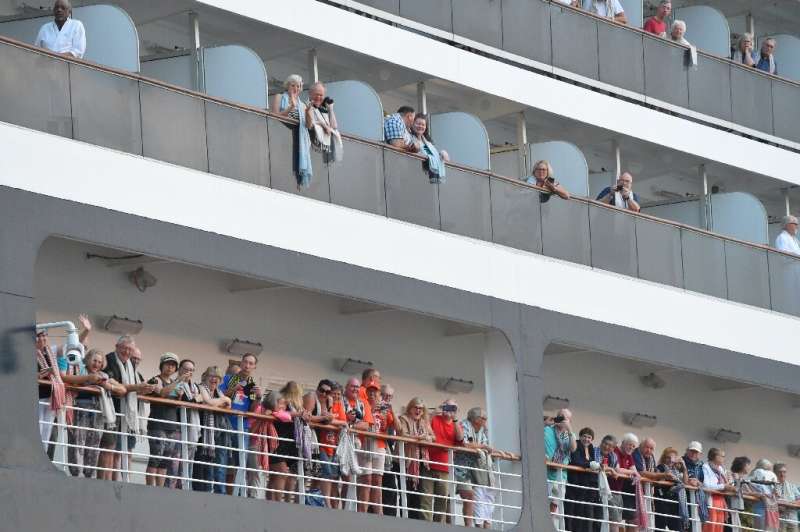 Passengers on the Westerdam cruise ship look on in Cambodia where the liner was allowed to dock after being refused entry at oth