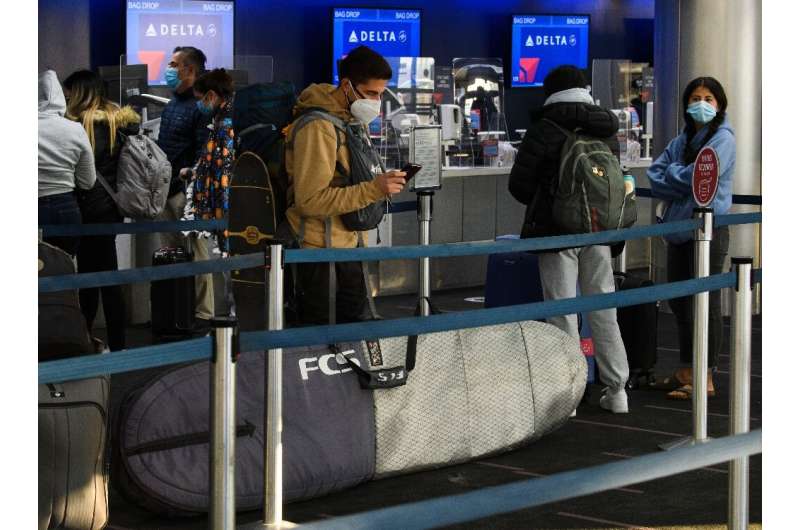Passengers wait in line to check-in for Delta Air Lines flights at Los Angeles International Airport ahead of the Thanksgiving h