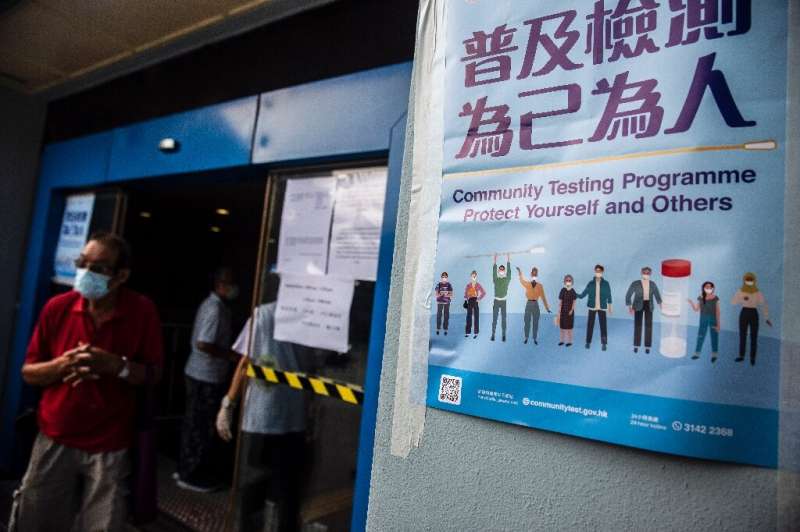 People wait at a COVID-19 coronavirus testing centre in Hong Kong