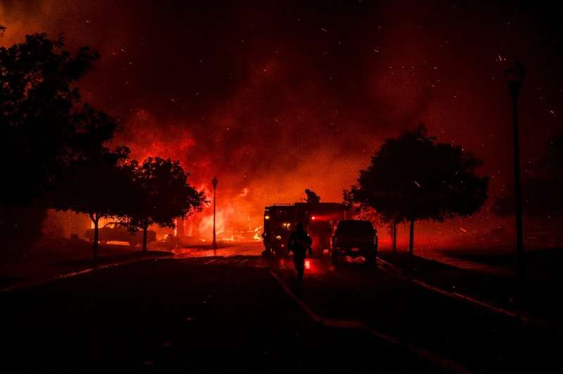 Fire fighters intervene as a home bursts into flames on the edge of Santa Rosa, on September 28, 2020