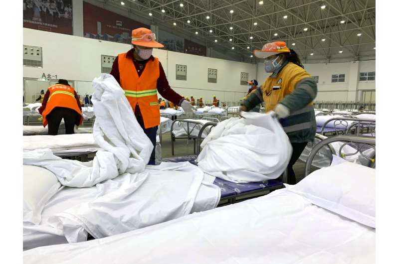 Hong Kong reports virus death as workers strike at hospitals