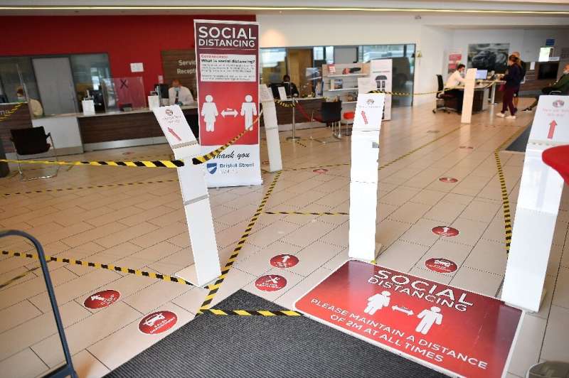 Social distancing markers are displayed inside the  recently re-opened Vauxhall car dealership as post-lockdown business takes o