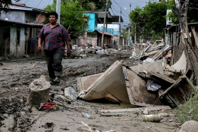 A man walks along a damaged street in La Lima, Honduras as Hurricane Iota approaches