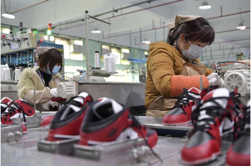 China's factories try to shield workers as output revives